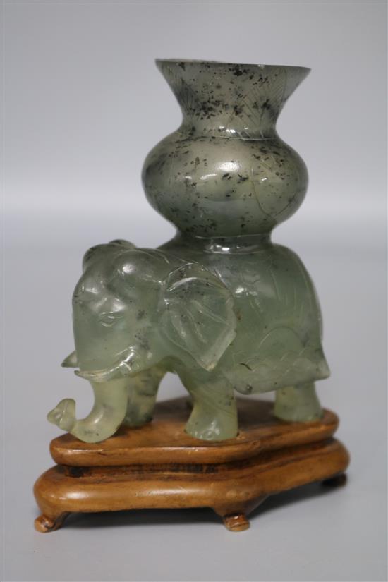 A translucent hardstone elephant with howdah vase surmount, grey/green with black inclusions